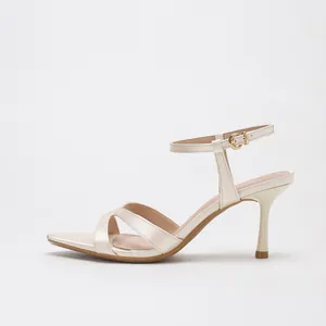 Elegant champagne satin sandals with cross straps, square toe, and slim high heel