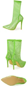 Macro view of neon green mesh stiletto ankle boots with rhinestone detail and pointed toe.