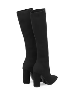 Black knit stretch knee-high boots with chunky high heels and pointed toes side view.