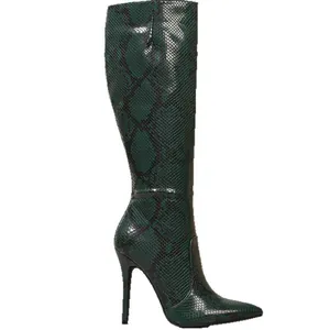 Close-up of green snakeskin knee-high boots with pointed toe and stiletto heels