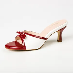 Elegant red and white color-block mule sandals with bow detail and kitten heels