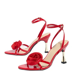 Detailed view of red satin high-heeled sandals featuring elegant rose flower accents