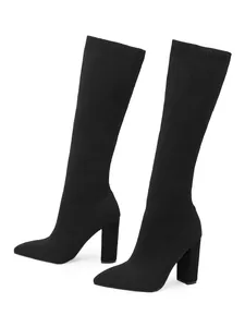 Side profile detail of black knit stretch boots featuring pointed toe and chunky high heel