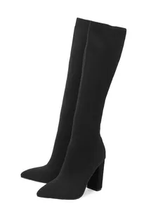 Close-up of black knit stretch high boots with pointed toe and stable block heel