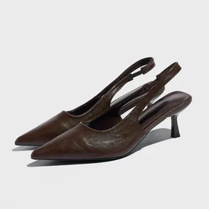 Elegant brown pointed-toe slingback kitten heels with textured leather finish.