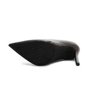 Detail view of brown patent leather stiletto heel and non-slip sole of women's pump shoe.