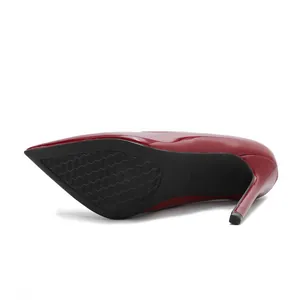 Detail view of the durable black sole and high stiletto heel of red patent leather pump