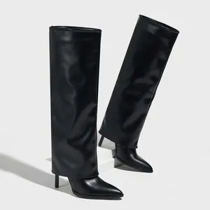Fashionable black pointed-toe pant-leg boots with high stiletto heels