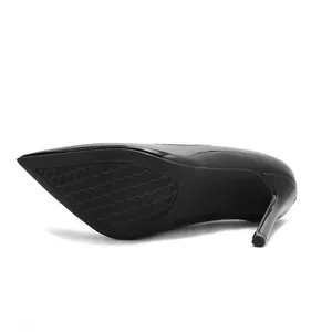 Detailed view of black patent leather stiletto pumps showing the textured anti-slip sole.