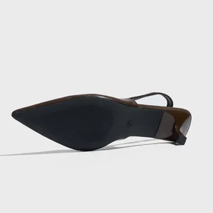 Detail view of the non-slip sole and 37 size mark on brown pointed slingback heels.