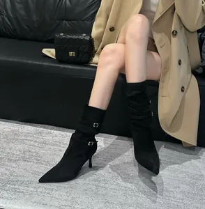 Pointed-toe black stiletto boots with buckle straps and slouchy pleated detail