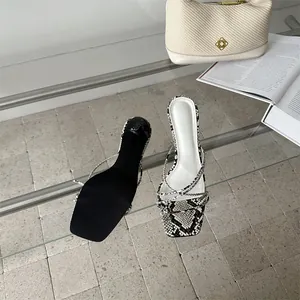 Λεπτομερής προβολή ψηλοτάκουνων πέδιλων με μοτίβο φιδιού, τετράγωνη μύτη και σόλα