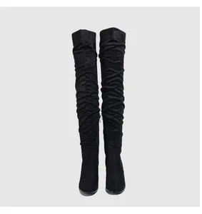 Front view showing the slouchy texture of black suede over-the-knee high heel boots.