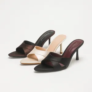 Elegant satin pointed-toe high-heeled mules with crossover straps for summer fashion.