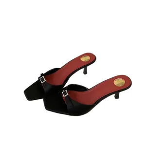 Elegant black kitten heel mules with red insoles and rhinestone square buckle detail