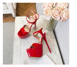 Close-up detail of sexy red patent leather platform sandals with extreme stiletto heels