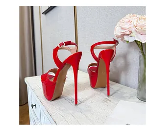 Side view of sexy red patent leather platform high heel sandals with ankle straps
