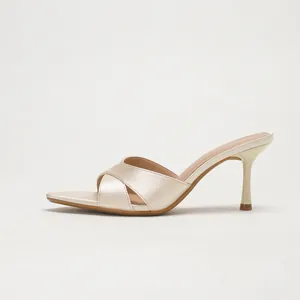 Champagne satin pointed-toe high-heeled mules featuring elegant cross straps design