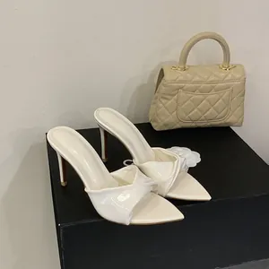 Elegante weiße spitze Pantoletten mit hohem Absatz und raffiniertem Knotendetail vorne