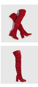 Detailed view of red suede thigh-high boots with chunky heels and side zipper.