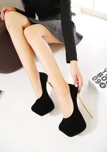 Detail view of sexy black suede platform high heels with elegant gold stiletto heel