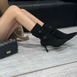 Elegant black suede-like pointed-toe stiletto ankle boots with buckle straps and pleated details