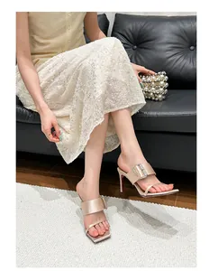 Elegant square-toe high-heel sandals with rhinestone buckle shown in a lifestyle setting
