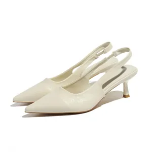 Elegant cream pointed-toe slingback kitten heels with premium leather grain texture.