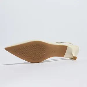 Detailed view of cream pointed toe slingback kitten heels showing non-slip sole