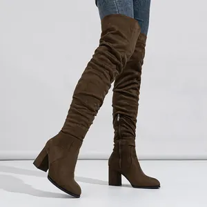 Fashionable brown suede over-the-knee boots featuring chunky high heels and side zippers