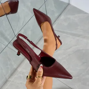 Detailed view of elegant burgundy pointed-toe slingback heels showcasing the leather texture