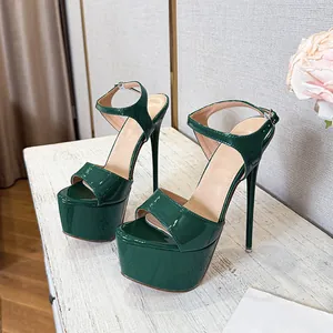 Detail of dark green patent leather platform sandals with sexy high stiletto heels and ankle strap.
