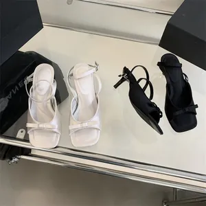 French style kitten heel sandals with bow detail and ankle strap in black and white