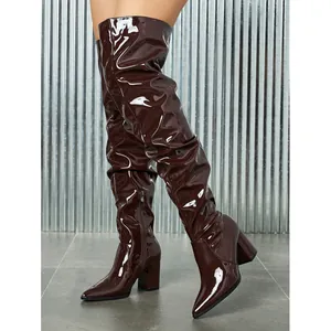 Chic chocolate brown patent leather slouchy thigh-high boots with pointed toe and block heel.