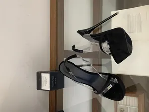 Side view of black platform sandals with transparent straps and high stiletto heels
