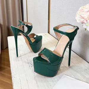 Elegant dark green patent leather platform sandals with stiletto heels and ankle straps
