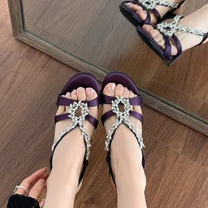 Elegant purple satin stiletto sandals with sparkling rhinestone chain and circular buckle