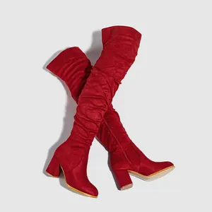 Fashionable red suede over-the-knee boots featuring chunky high heels and slouchy shaft design