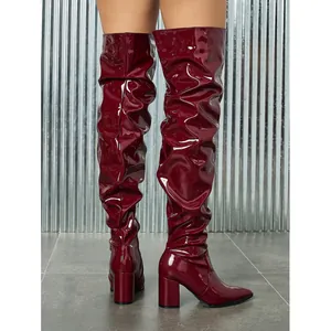 Wine red patent leather slouchy over-the-knee boots with pointed toe and chunky heel