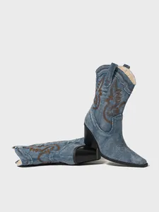 Vintage denim cowboy boots featuring brown embroidery, pointed toe and chunky heel