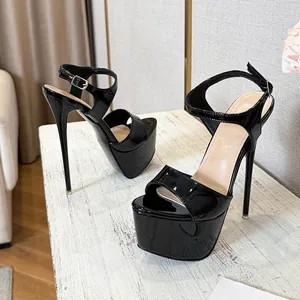 Close-up detail of black patent leather platform high heel sandals with thin heels