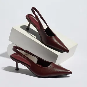Macro view of burgundy pointed toe slingback high heels showing premium leather texture