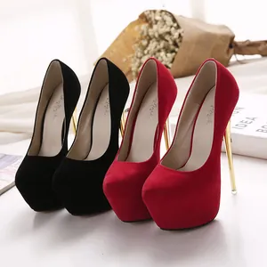 Detailed view of elegant red and black suede platform pumps with high gold stilettos