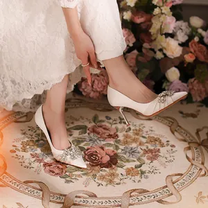 Elegant white pointed toe high heels with sparkling crystal rhinestone embellishments for wedding
