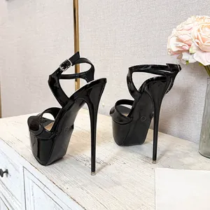 Elegant black patent leather platform sandals featuring extreme stiletto high heels for women