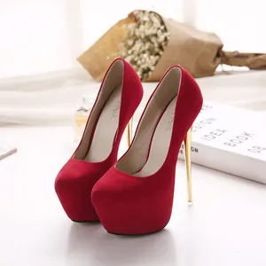 Close-up of vibrant red suede platform pumps featuring elegant gold-colored stiletto heels
