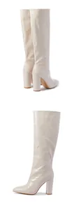 Cream crocodile embossed knee-high boots with pointed toe and block high heel.