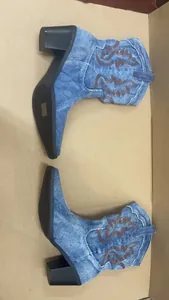 Denim western boots featuring vintage brown embroidery and black chunky heels detail