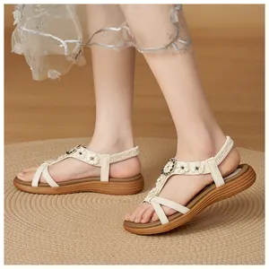 Detailed view of Bohemian cream sandals with flower buckle and elastic strap.