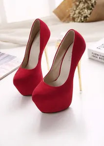 Close-up of red suede platform pumps featuring a striking gold stiletto heel detail.